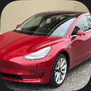 A red sedan parked on a street